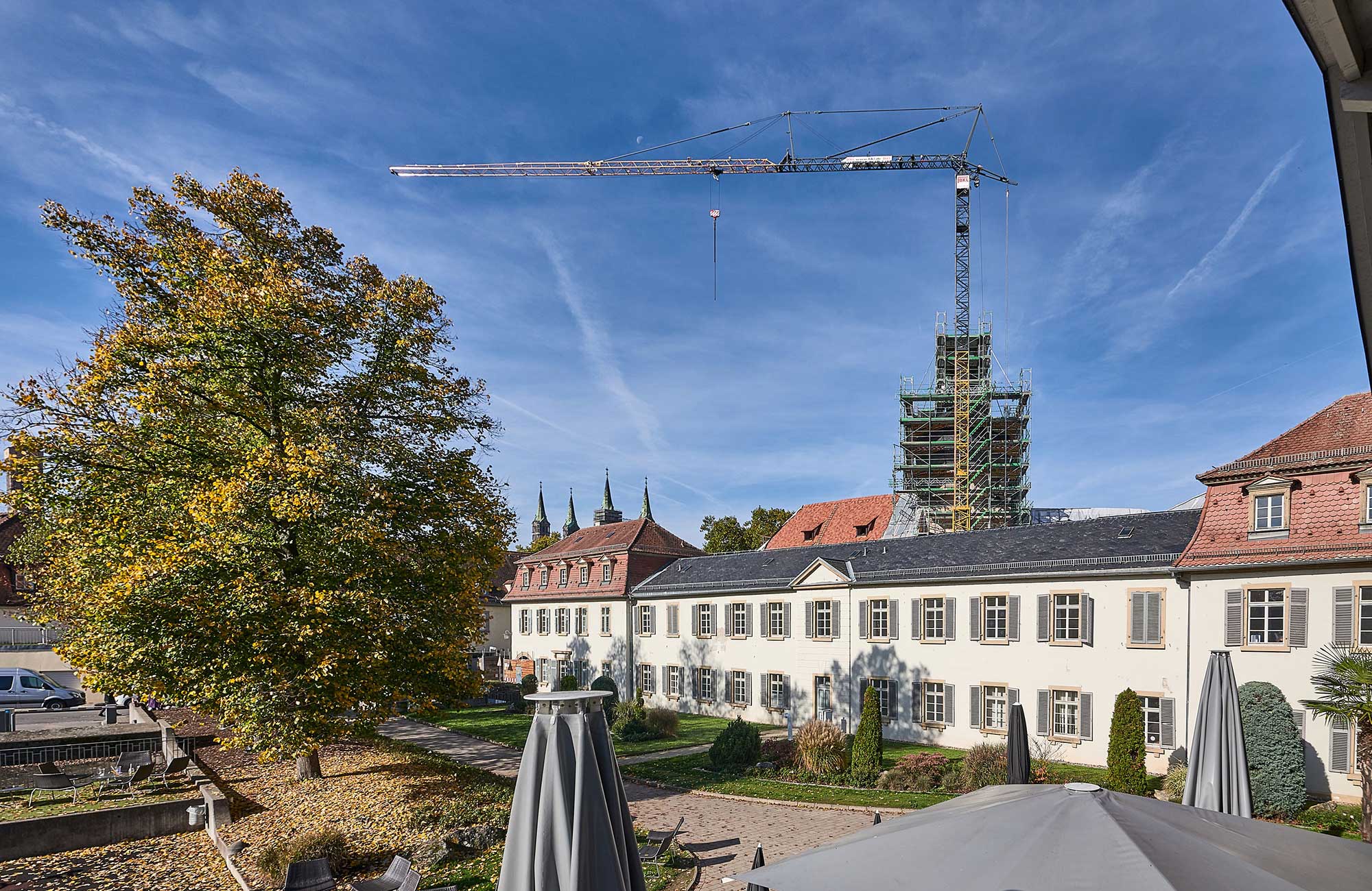 Liebherr 81K aus der Kranflotte der BKL Baukran Logistik vor blauem Himmel am Schloß Geyerswörth für Sanierungsarbeiten